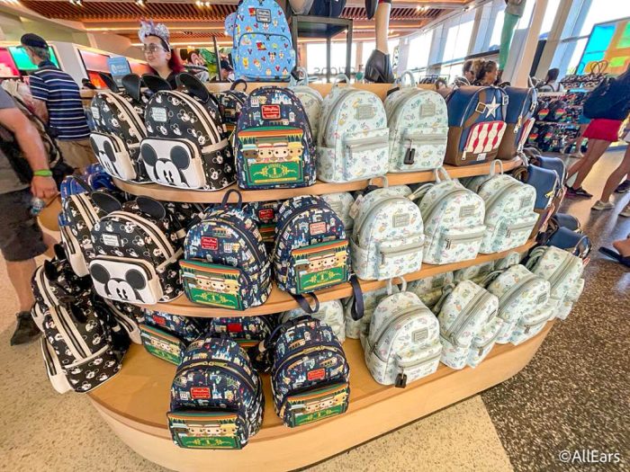 Disney backpacks for sale on a shelf in Disney World